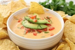 Easy Nacho Cheese sauce recipe with only 4 ingredients and is made in minutes! Smooth, creamy with great nacho cheese flavor, this recipe is perfect for parties, busy weeknight dinners and game day food!