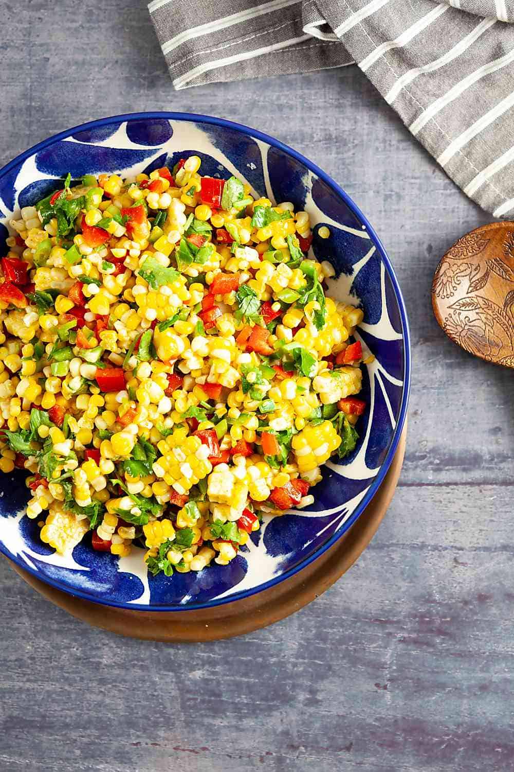 Bowl of Corn Salad with a serving spoon and a napkin