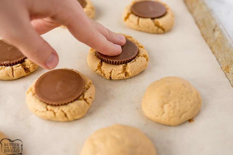Reese's peanut butter cup being pressed into the baked peanut butter cookie