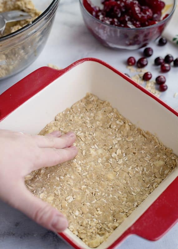 Patting crust in pan for Cranberry Crunch