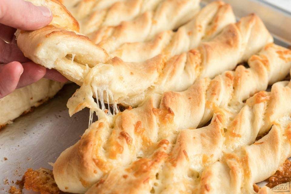 Cheesy breadsticks are a delicious side to a meal and these soft and buttery breadsticks with cheese inside can be made in under an hour!