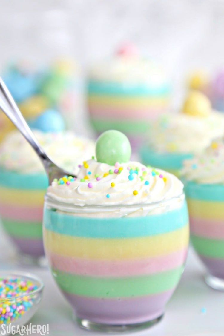 Close-up of striped pastel gelatin cup with a spoon sticking out of the top