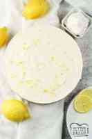 lemon cheesecake surrounded by lemons and whipped cream