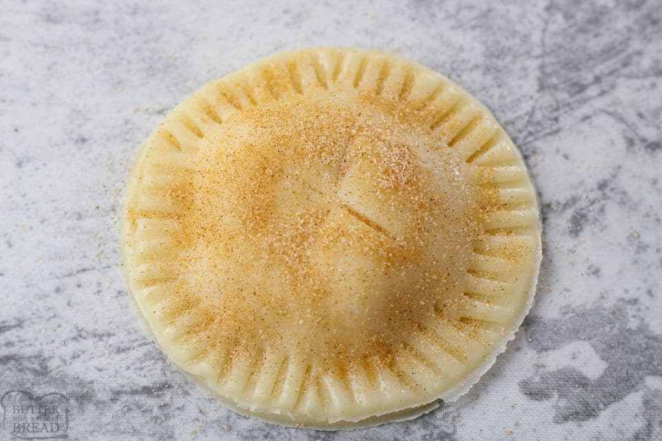 small apple pie with cinnamon sugar on time before baking