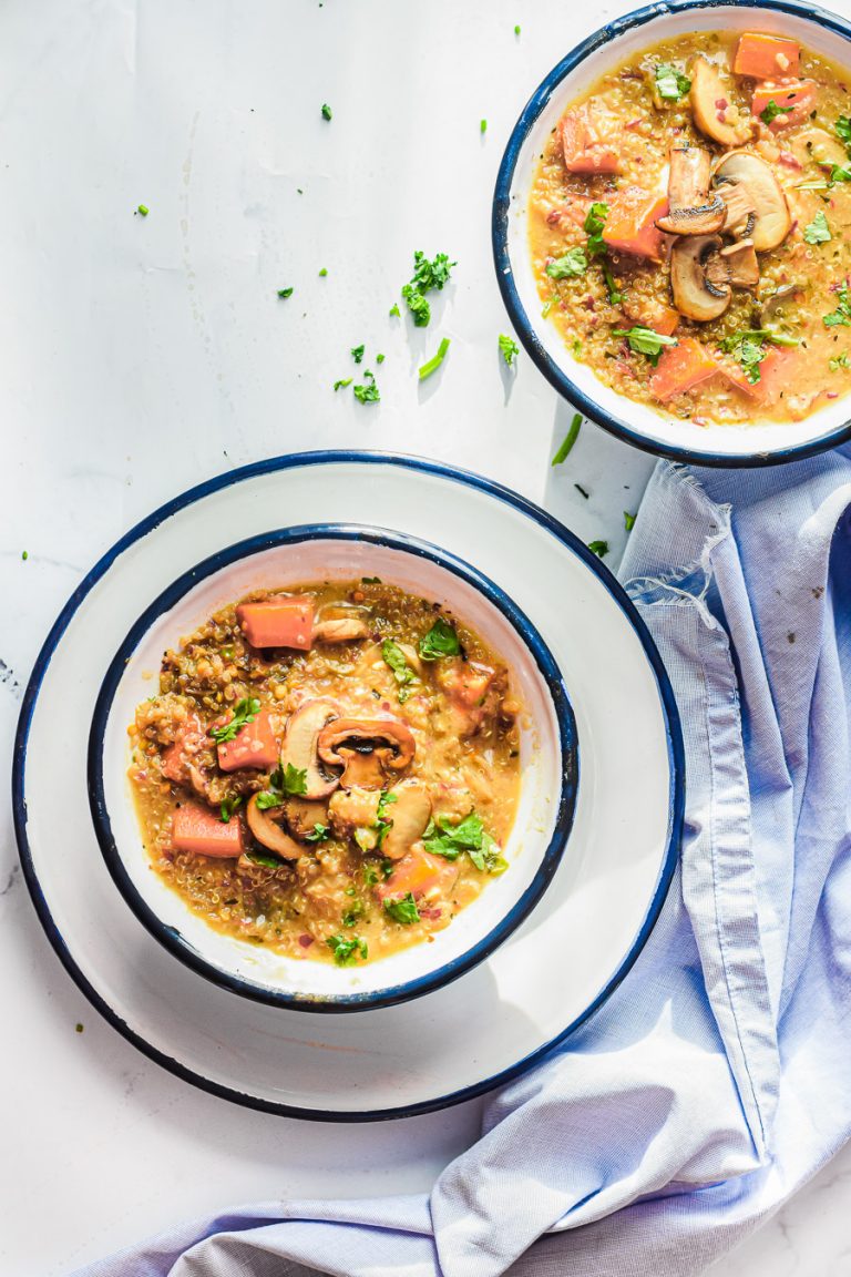 overhead view of two bowls of mushroom and quinoa soup