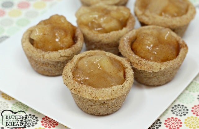  Snickerdoodle Apple Pie Cookie Cups combine two favorite desserts in a bite sized treat! Mini apple pies with a snickerdoodle cookie crust!